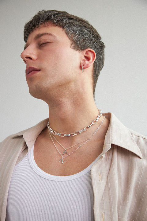 A delicate letter N pendant necklace inlaid with a natural diamond of 0.007 ct and 1.2 mm diameter. Suspended on a 50 cm chain, this timeless initial design offers a personal and elegant way to celebrate someone special. A refined keepsake that never goes out of style. Discover meaningful jewelry by UMIAR jewelry.