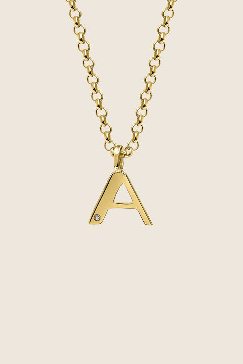 A delicate letter A pendant necklace inlaid with a natural diamond of 0.007 ct and 1.2 mm diameter. Suspended on a 50 cm chain, this timeless initial design offers a personal and elegant way to celebrate someone special. A refined keepsake that never goes out of style. Discover meaningful jewelry by UMIAR jewelry.