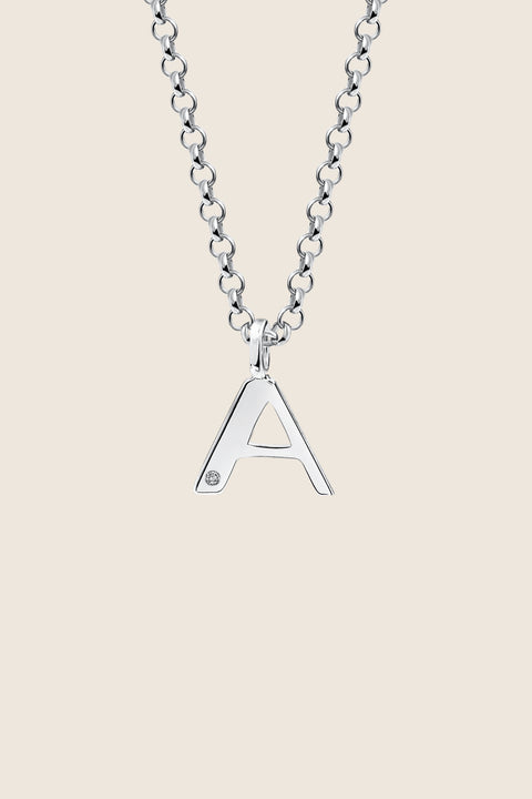 A delicate letter A pendant necklace inlaid with a natural diamond of 0.007 ct and 1.2 mm diameter. Suspended on a 50 cm chain, this timeless initial design offers a personal and elegant way to celebrate someone special. A refined keepsake that never goes out of style. Discover meaningful jewelry by UMIAR jewelry.