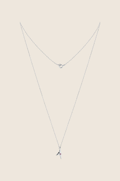 Discover our minimalist necklace featuring a pendant inspired by the delicate thorn of a rose — a subtle way to elevate your elegant style. The design is accented with a natural ruby (2 mm, 0.05 ct) for a refined touch of colour. Handcrafted entirely from precious materials: 925 sterling silver or 925 silver plated with 24-carat gold.