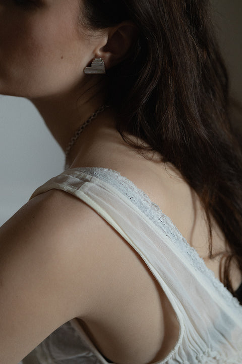 Large, statement heart-shaped earrings with dynamic fluted lines. Avant-garde yet elegant — perfect for power-dressing looks and minimalist outfits alike. Handcrafted from 925 sterling silver and beautifully reflective. An ideal Valentine’s gift. Discover UMIAR jewellery!
