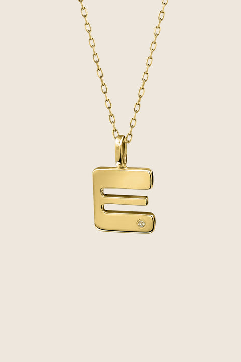 A delicate letter A pendant necklace inlaid with a natural diamond of 0.007 ct and 1.2 mm diameter. Suspended on a 50 cm chain, this timeless initial design offers a personal and elegant way to celebrate someone special. A refined keepsake that never goes out of style. Discover meaningful jewelry by UMIAR jewelry.
