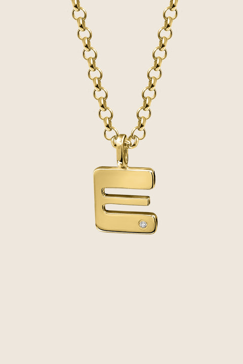 A delicate letter A pendant necklace inlaid with a natural diamond of 0.007 ct and 1.2 mm diameter. Suspended on a 50 cm chain, this timeless initial design offers a personal and elegant way to celebrate someone special. A refined keepsake that never goes out of style. Discover meaningful jewelry by UMIAR jewelry.