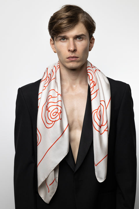 Discover a silk scarf with an original rose design by UMIAR jewellery, where the clean outline of a rose meets a striking colour palette of ecru and carmine. A perfect fusion of elegance and fashion in one accessory. This exceptional scarf, made from 100% natural silk, is part of the PROFONDO ROSSO collection. An ideal gift — beautifully packaged and ready to delight. Explore unique jewellery and silk scarves by UMIAR.