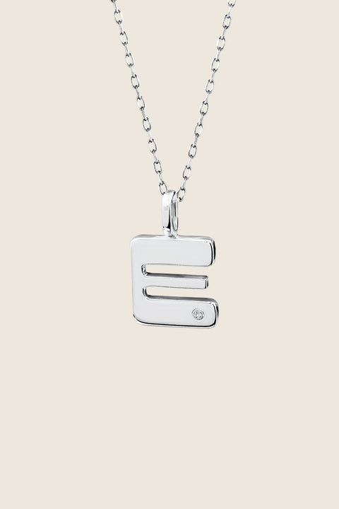 A delicate letter A pendant necklace inlaid with a natural diamond of 0.007 ct and 1.2 mm diameter. Suspended on a 50 cm chain, this timeless initial design offers a personal and elegant way to celebrate someone special. A refined keepsake that never goes out of style. Discover meaningful jewelry by UMIAR jewelry.