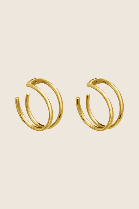 Discover the versatility of these specially designed earring attachments, echoing the form of doubled rings. They allow you to adapt your earrings to the moment and your mood, wearing them in any configuration — with ARNO hoops, DOTA studs, or paired with other earrings from your collection. Handcrafted from  925 sterling silver, 24k gold-plated 925 silver, and 14k gold.