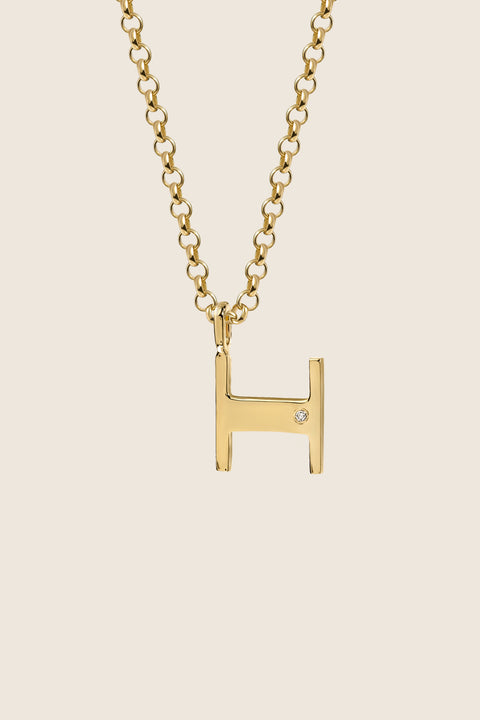 A delicate letter H pendant necklace inlaid with a natural diamond of 0.007 ct and 1.2 mm diameter. Suspended on a 50 cm chain, this timeless initial design offers a personal and elegant way to celebrate someone special. A refined keepsake that never goes out of style. Discover meaningful jewelry by UMIAR jewelry.