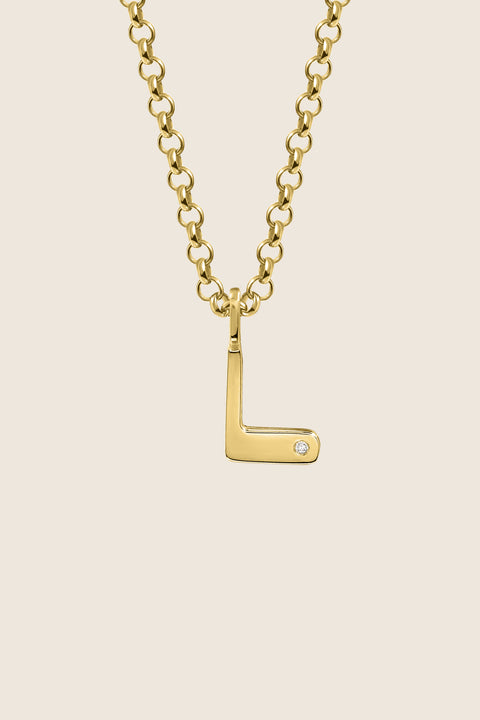 A delicate letter L pendant necklace inlaid with a natural diamond of 0.007 ct and 1.2 mm diameter. Suspended on a 50 cm chain, this timeless initial design offers a personal and elegant way to celebrate someone special. A refined keepsake that never goes out of style. Discover meaningful jewelry by UMIAR jewelry.