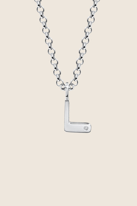 A delicate letter L pendant necklace inlaid with a natural diamond of 0.007 ct and 1.2 mm diameter. Suspended on a 50 cm chain, this timeless initial design offers a personal and elegant way to celebrate someone special. A refined keepsake that never goes out of style. Discover meaningful jewelry by UMIAR jewelry.