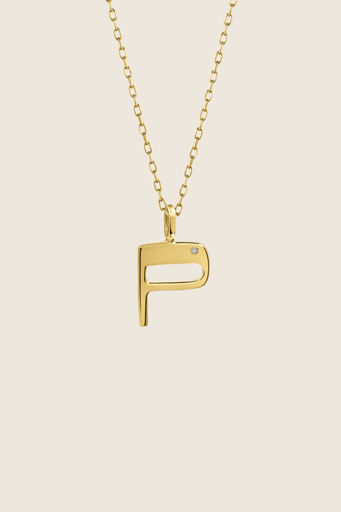 A delicate letter P pendant necklace inlaid with a natural diamond of 0.007 ct and 1.2 mm diameter. Suspended on a 50 cm chain, this timeless initial design offers a personal and elegant way to celebrate someone special. A refined keepsake that never goes out of style. Discover meaningful jewelry by UMIAR jewelry.