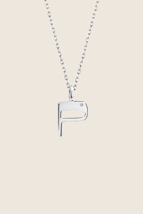A delicate letter P pendant necklace inlaid with a natural diamond of 0.007 ct and 1.2 mm diameter. Suspended on a 50 cm chain, this timeless initial design offers a personal and elegant way to celebrate someone special. A refined keepsake that never goes out of style. Discover meaningful jewelry by UMIAR jewelry.