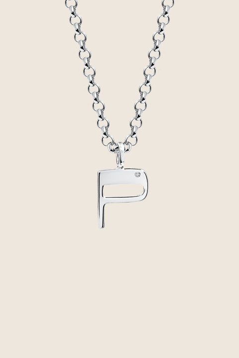 A delicate letter P pendant necklace inlaid with a natural diamond of 0.007 ct and 1.2 mm diameter. Suspended on a 50 cm chain, this timeless initial design offers a personal and elegant way to celebrate someone special. A refined keepsake that never goes out of style. Discover meaningful jewelry by UMIAR jewelry.