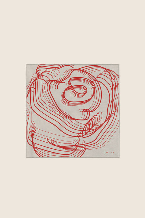 Discover a silk scarf with an original rose design by UMIAR jewellery, where expressive lines form a distinctive floral composition. Contrasting shades of ecru and carmine blend elegance with modern style. This exceptional scarf, made from 100% natural silk, is part of the PROFONDO ROSSO collection. A perfect gift — beautifully packaged and ready to delight. Explore unique jewellery and silk scarves by UMIAR.