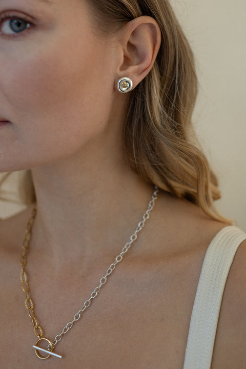 Round, elegant disc-shaped earrings with a subtle indentation, where a small setting with a natural diamond (0.007 ct) is placed. A refined and minimalist design, perfectly suited for both everyday wear and special occasions. Choose UMIAR jewelry and highlight your uniqueness!