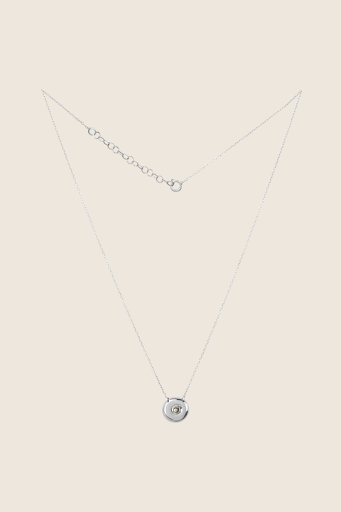 Discover the elegant pendant necklace with a natural diamond by UMIAR jewellery, handcrafted from 925 sterling silver. Its unique round disc with a recessed bead blends timeless style with a modern touch, symbolising femininity, closeness, and the cycles of life. A perfect gift for special occasions — shop now!