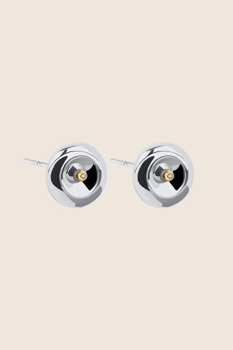Round, elegant disc-shaped earrings with a subtle indentation, where a small setting with a natural diamond (0.007 ct) is placed. A refined and minimalist design, perfectly suited for both everyday wear and special occasions. Choose UMIAR jewelry and highlight your uniqueness!