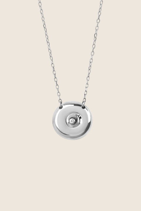 Discover the elegant pendant necklace with a natural diamond by UMIAR jewellery, handcrafted from 925 sterling silver. Its unique round disc with a recessed bead blends timeless style with a modern touch, symbolising femininity, closeness, and the cycles of life. A perfect gift for special occasions — shop now!