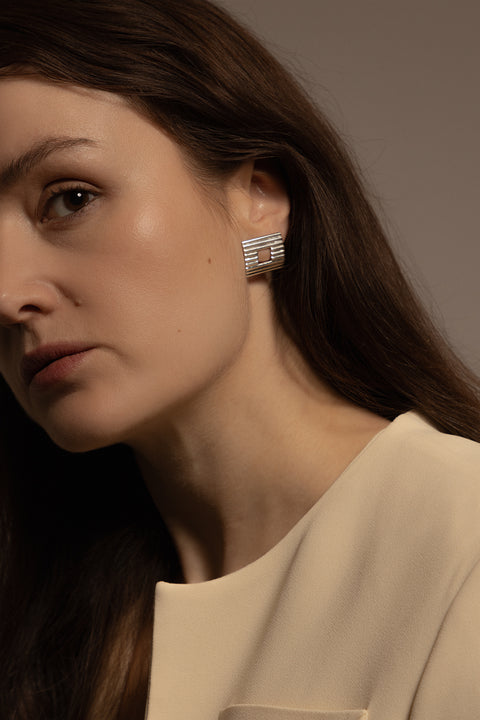 Large Square Earrings from UMIAR Jewelry – Elegant design with decorative ribbed lines and a playful "window" in the center. Handcrafted from 925 sterling silver or 24-karat gold plating. Perfect for power dressing and minimalist looks. Choose UMIAR Jewelry's square earrings to add unique character and timeless elegance to your outfits.