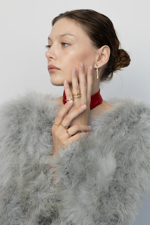 Discover two-part earrings set with rubies and inspired by the branch of a rose by UMIAR jewellery. Their design blends simple forms with refined texture, highlighting the natural beauty of the stones. Crafted from 925 sterling silver and 925 silver plated with 24-carat gold, they are an elegant addition to any look. Let the charm of the rose grace your ears today!