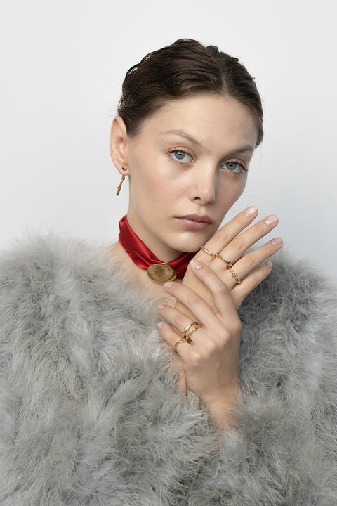 Discover two-part earrings set with rubies and inspired by the branch of a rose by UMIAR jewellery. Their design blends simple forms with refined texture, highlighting the natural beauty of the stones. Crafted from 925 sterling silver and 925 silver plated with 24-carat gold, they are an elegant addition to any look. Let the charm of the rose grace your ears today!