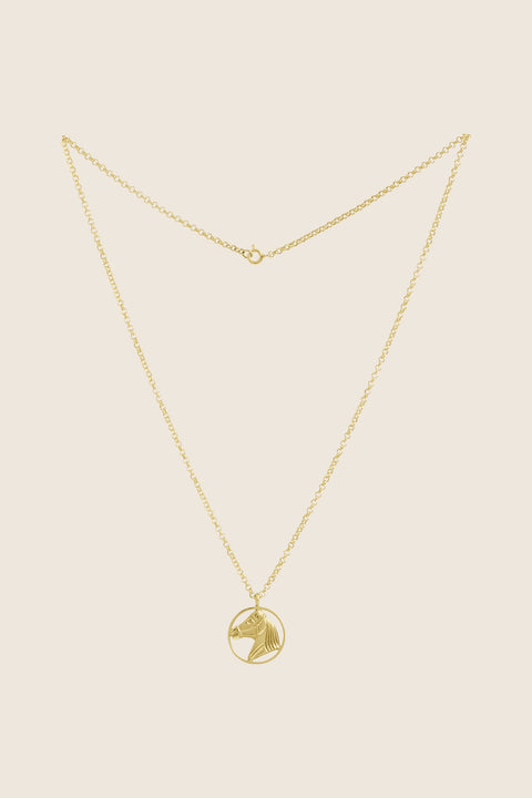 An elegant necklace featuring a hand-sculpted horse pendant, crafted in 14k yellow gold. It embodies the symbolism of strength, freedom and timeless elegance. A unique talisman for those who appreciate refined style and jewelry with an artistic character. Discover the exceptional quality of UMIAR jewelry and order online.