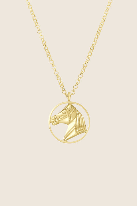 An elegant necklace featuring a hand-sculpted horse pendant, crafted in 14k yellow gold. It embodies the symbolism of strength, freedom and timeless elegance. A unique talisman for those who appreciate refined style and jewelry with an artistic character. Discover the exceptional quality of UMIAR jewelry and order online.
