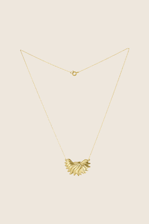 The IGNIS decorative necklace crafted in 14k gold features a sculpted flame pendant — a symbol of strength, courage and love. Vintage inspiration meets modern character, creating a timeless accent that rests beautifully on the neckline and complements both everyday and evening looks. Discover UMIAR jewelry.