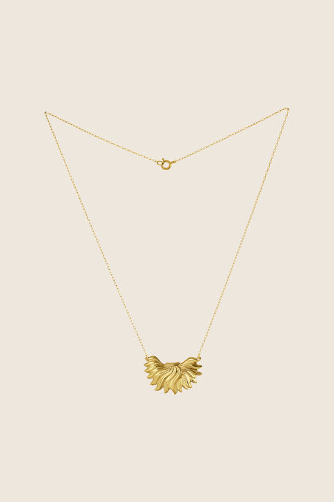 The IGNIS decorative necklace, featuring an intricately sculpted flame, symbolizes strength, courage and love. Inspired by a vintage spirit yet maintaining a modern character, it sits beautifully on the neckline and enhances any look. A timeless UMIAR jewelry piece — discover it and order online.
