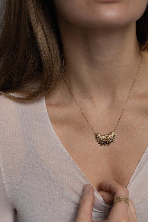 The IGNIS decorative necklace, featuring an intricately sculpted flame, symbolizes strength, courage and love. Inspired by a vintage spirit yet maintaining a modern character, it sits beautifully on the neckline and enhances any look. A timeless UMIAR jewelry piece — discover it and order online.