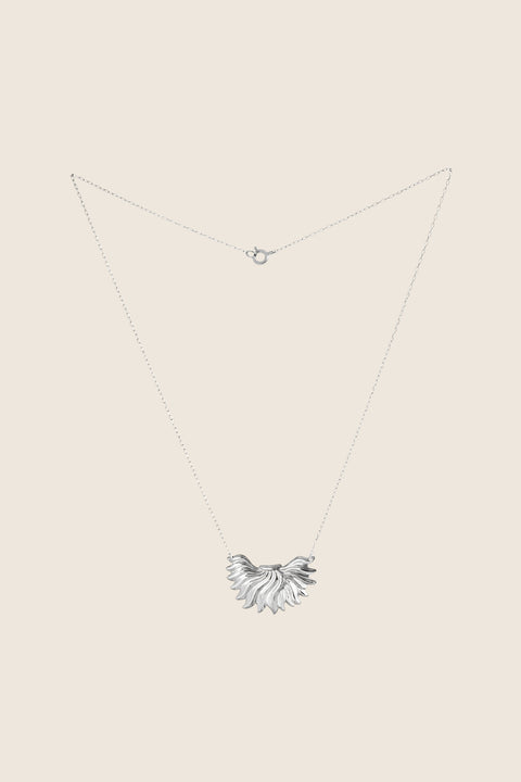 The IGNIS decorative necklace, featuring an intricately sculpted flame, symbolizes strength, courage and love. Inspired by a vintage spirit yet maintaining a modern character, it sits beautifully on the neckline and enhances any look. A timeless UMIAR jewelry piece — discover it and order online.