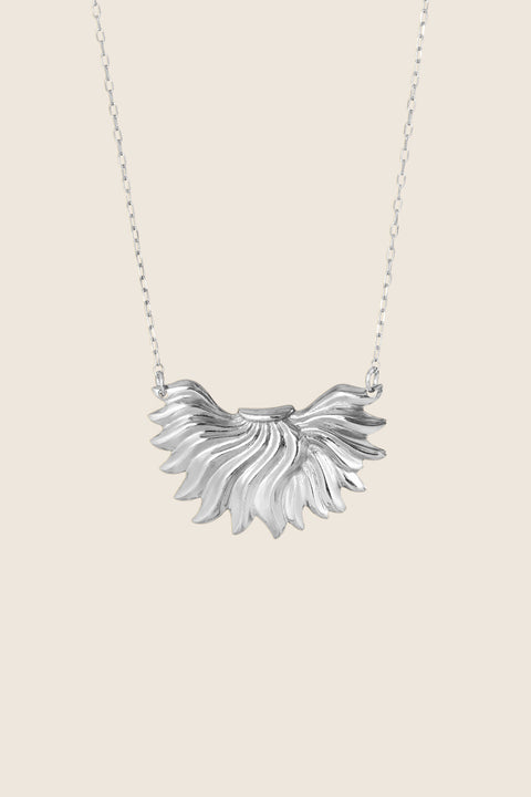 The IGNIS decorative necklace, featuring an intricately sculpted flame, symbolizes strength, courage and love. Inspired by a vintage spirit yet maintaining a modern character, it sits beautifully on the neckline and enhances any look. A timeless UMIAR jewelry piece — discover it and order online.