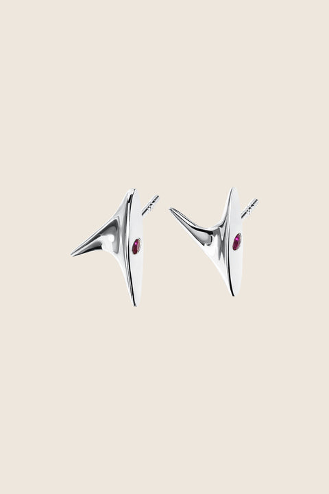 Discover the elegant stud earrings from UMIAR’s PROFONDO ROSSO collection. Inspired by the delicate thorn of a rose, they carry a subtle yet striking charm. Crafted from high-quality 925 sterling silver and 24-carat gold-plated silver, these earrings are not only visually exquisite but also durable. Adorned with two natural rubies, they offer a unique touch of brilliance. Perfect for those who appreciate elegance and finesse in jewellery.