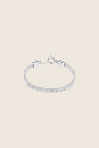 Discover the delicate bracelet-band from UMIAR jewelry, crafted from silver filigree. This decorative band, inspired by the ribbed stripes of silk, is an original hand ornament. It pairs beautifully with any type of jewelry, adding elegance to any outfit. Available in a limited edition. Add a unique touch to your collection today!