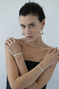 Discover the delicate bracelet-band from UMIAR jewelry, crafted from silver filigree. This decorative band, inspired by the ribbed stripes of silk, is an original hand ornament. It pairs beautifully with any type of jewelry, adding elegance to any outfit. Available in a limited edition. Add a unique touch to your collection today!