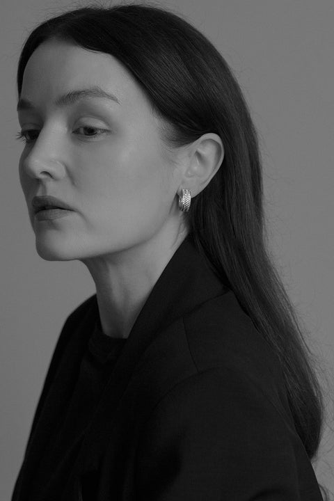 These striking hoop earrings with a textured braided finish combine modern style with timeless elegance. Crafted in 925 sterling silver or gold-plated sterling silver, they beautifully catch the light, adding a dynamic accent to both everyday and evening looks. Discover the quality of UMIAR jewelry and enrich your collection with a bold, distinctive detail.