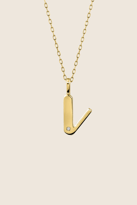 A delicate letter V pendant necklace inlaid with a natural diamond of 0.007 ct and 1.2 mm diameter. Suspended on a 50 cm chain, this timeless initial design offers a personal and elegant way to celebrate someone special. A refined keepsake that never goes out of style. Discover meaningful jewelry by UMIAR jewelry.
