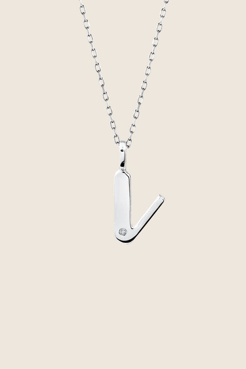 A delicate letter V pendant necklace inlaid with a natural diamond of 0.007 ct and 1.2 mm diameter. Suspended on a 50 cm chain, this timeless initial design offers a personal and elegant way to celebrate someone special. A refined keepsake that never goes out of style. Discover meaningful jewelry by UMIAR jewelry.