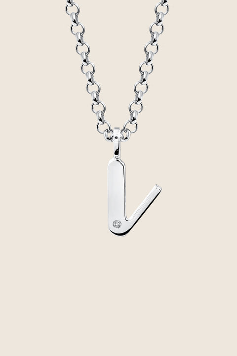 A delicate letter V pendant necklace inlaid with a natural diamond of 0.007 ct and 1.2 mm diameter. Suspended on a 50 cm chain, this timeless initial design offers a personal and elegant way to celebrate someone special. A refined keepsake that never goes out of style. Discover meaningful jewelry by UMIAR jewelry.