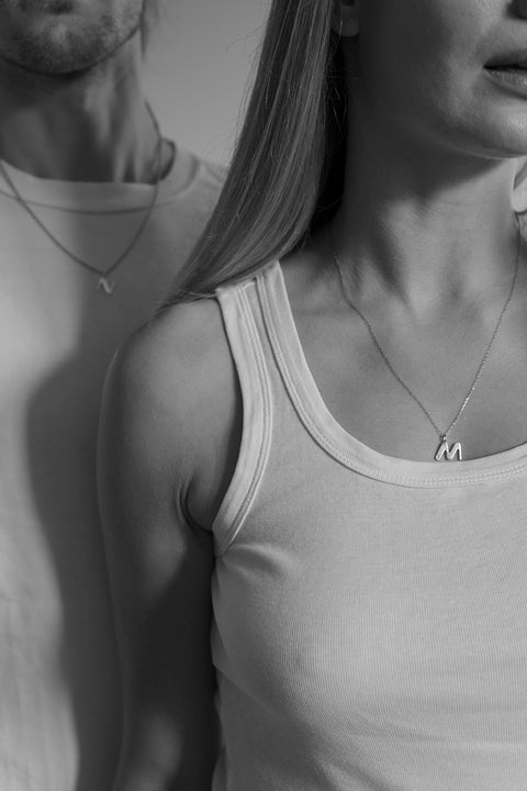 A delicate letter N pendant necklace inlaid with a natural diamond of 0.007 ct and 1.2 mm diameter. Suspended on a 50 cm chain, this timeless initial design offers a personal and elegant way to celebrate someone special. A refined keepsake that never goes out of style. Discover meaningful jewelry by UMIAR jewelry.