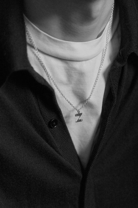 A delicate letter Z pendant necklace inlaid with a natural diamond of 0.007 ct and 1.2 mm diameter. Suspended on a 50 cm chain, this timeless initial design offers a personal and elegant way to celebrate someone special. A refined keepsake that never goes out of style. Discover meaningful jewelry by UMIAR jewelry.
