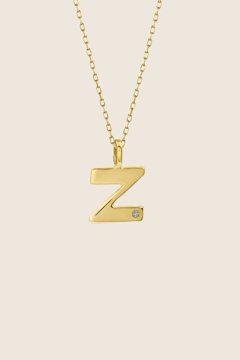A delicate letter Z pendant necklace inlaid with a natural diamond of 0.007 ct and 1.2 mm diameter. Suspended on a 50 cm chain, this timeless initial design offers a personal and elegant way to celebrate someone special. A refined keepsake that never goes out of style. Discover meaningful jewelry by UMIAR jewelry.