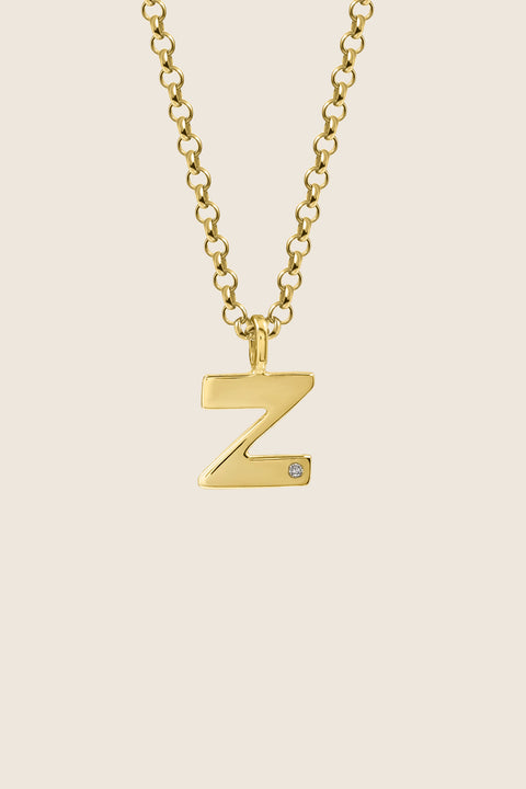A delicate letter Z pendant necklace inlaid with a natural diamond of 0.007 ct and 1.2 mm diameter. Suspended on a 50 cm chain, this timeless initial design offers a personal and elegant way to celebrate someone special. A refined keepsake that never goes out of style. Discover meaningful jewelry by UMIAR jewelry.