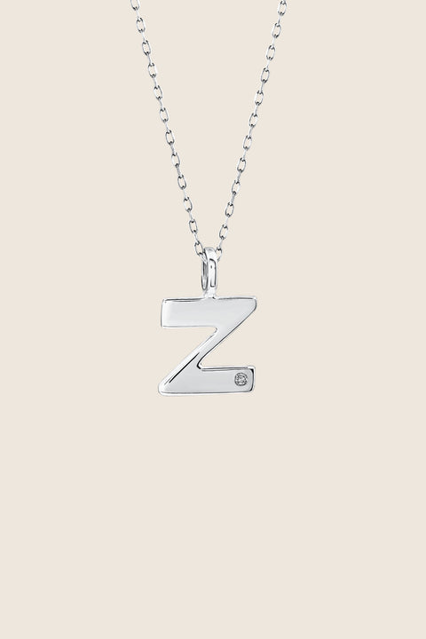 A delicate letter Z pendant necklace inlaid with a natural diamond of 0.007 ct and 1.2 mm diameter. Suspended on a 50 cm chain, this timeless initial design offers a personal and elegant way to celebrate someone special. A refined keepsake that never goes out of style. Discover meaningful jewelry by UMIAR jewelry.