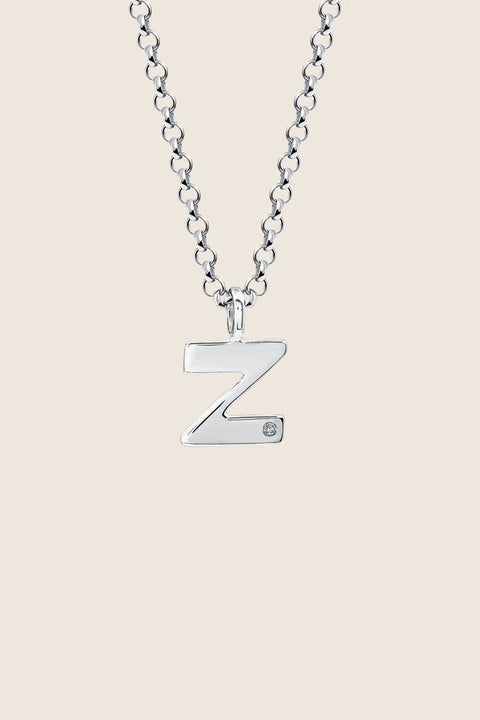 A delicate letter Z pendant necklace inlaid with a natural diamond of 0.007 ct and 1.2 mm diameter. Suspended on a 50 cm chain, this timeless initial design offers a personal and elegant way to celebrate someone special. A refined keepsake that never goes out of style. Discover meaningful jewelry by UMIAR jewelry.