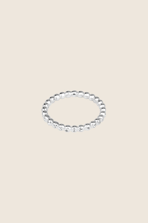 A timeless band ring fully inlaid with fine gemstones set in a refined beaded setting. Available with diamonds or sapphires, it balances minimalist form with decorative brilliance. Featuring 1.25 mm stones, it is ideal as a modern wedding band or distinctive engagement ring. Discover subtle elegance by UMIAR jewelry.