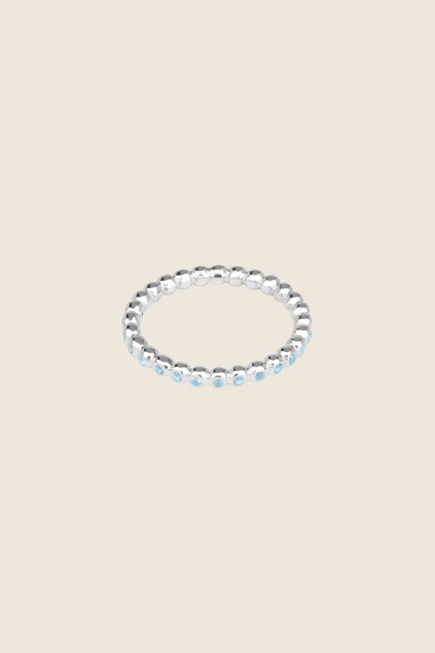 A timeless band ring fully inlaid with fine gemstones set in a refined beaded setting. Available with diamonds or sapphires, it balances minimalist form with decorative brilliance. Featuring 1.25 mm stones, it is ideal as a modern wedding band or distinctive engagement ring. Discover subtle elegance by UMIAR jewelry.