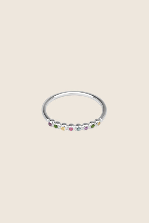 An elegant band ring featuring eight gemstones set in a refined beaded setting. Available with diamonds or topaz stones in monochrome or colorful combinations, this versatile design blends contemporary style with timeless elegance. Featuring 1.25 mm stones, it pairs beautifully with PLURES bands and the ILLE III ring. Discover refined versatility by UMIAR jewelry.
