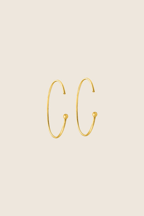 Minimalist hoop earrings made from fine wire with a subtle ball detail. Featuring a 30 mm diameter and a thread-through design with no clasp, they offer effortless elegance for everyday casual looks. A refined essential inspired by modern minimalism. Discover understated style by UMIAR jewelry.