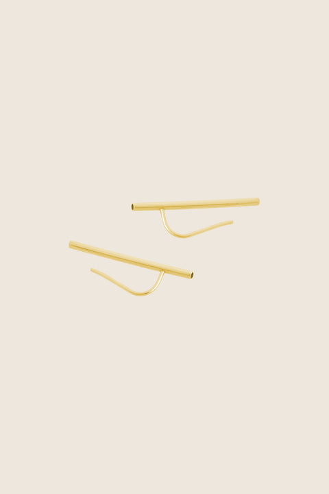 Monolithic earrings featuring a tubular form and fine threader wire, designed for versatile styling. Wear them as a sleek line along the earlobe or as a dangling accent. A sculptural, minimalist piece that combines modern design with effortless adaptability. Discover contemporary jewelry by UMIAR jewelry.