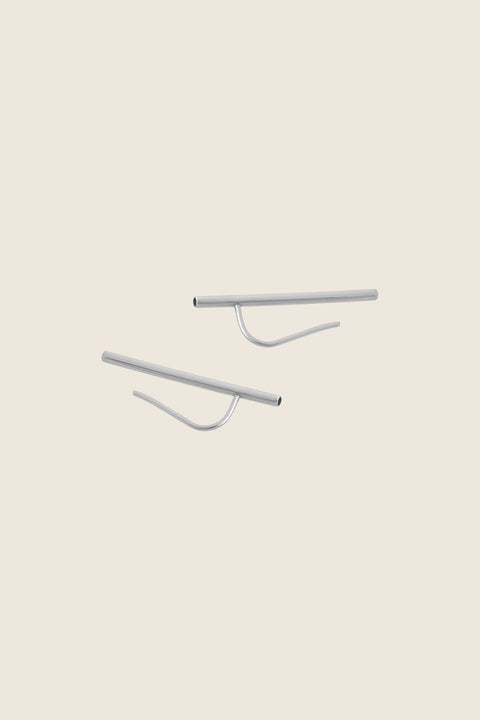 Monolithic earrings featuring a tubular form and fine threader wire, designed for versatile styling. Wear them as a sleek line along the earlobe or as a dangling accent. A sculptural, minimalist piece that combines modern design with effortless adaptability. Discover contemporary jewelry by UMIAR jewelry.